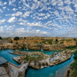 View of the historic Shushtar water mills and cascading falls, part of the UNESCO-listed Shushtar Historical Hydraulic System in Khuzestan Province, showcasing ancient Persian engineering and flowing Karun River waters.